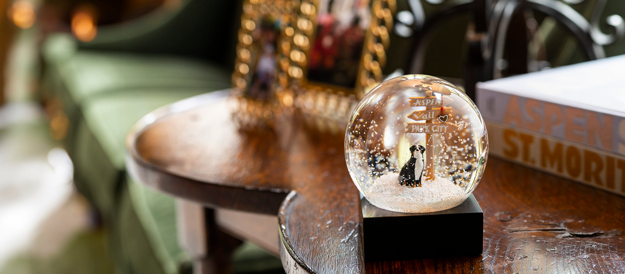 Exclusive Gorsuch snow globe featuring a Bernese Mountain Dog in front of a sign with the names Aspen, Vail, and Park City.