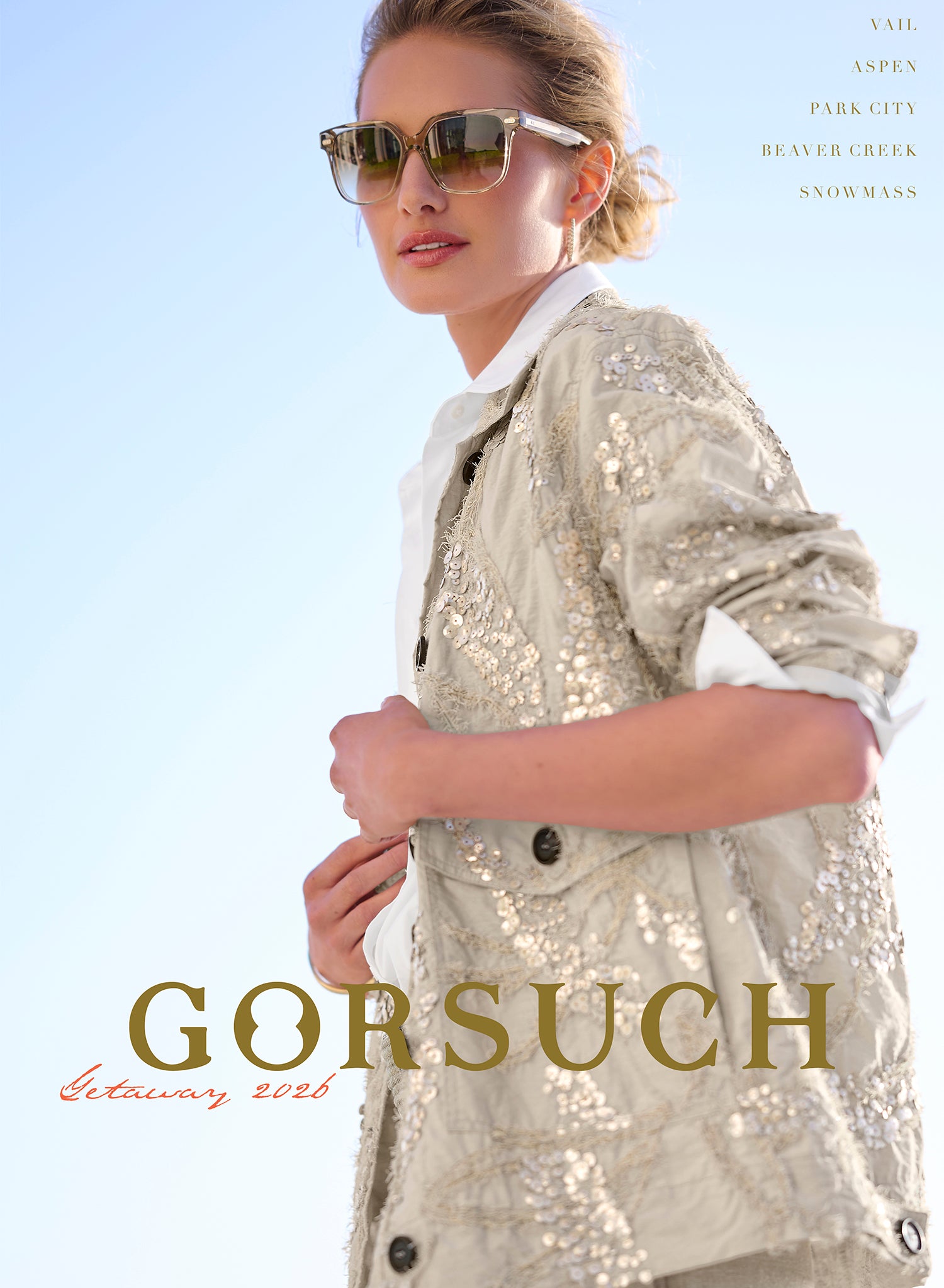 Woman wearing a sequined jacket with sunglasses, standing against a clear blue sky. 'Gorsuch' brand name displayed.