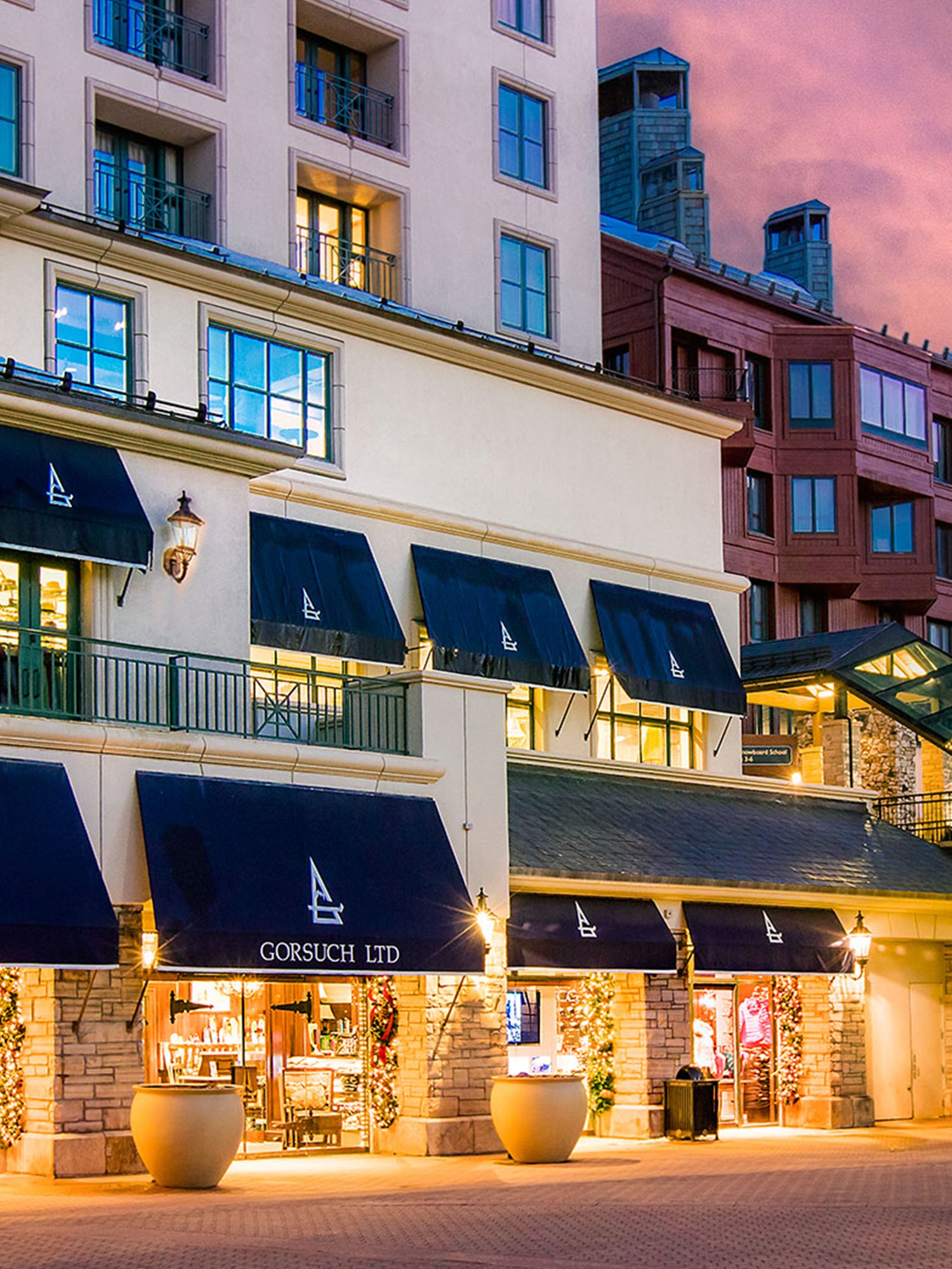 Beaver Creek Gorsuch store front at dusk with navy and white Gorsuch Awnings.