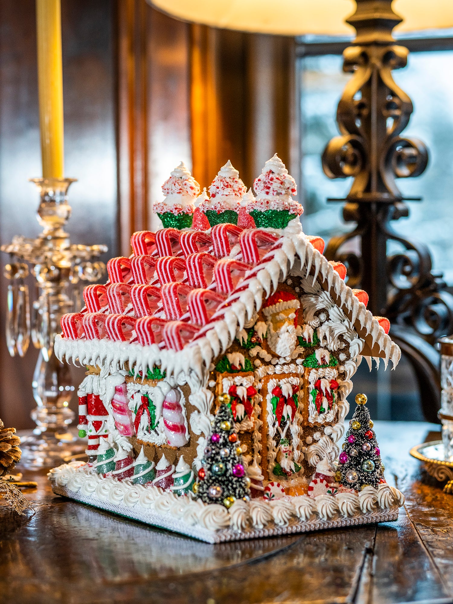 Decorative gingerbread house with candy details displayed on a table.