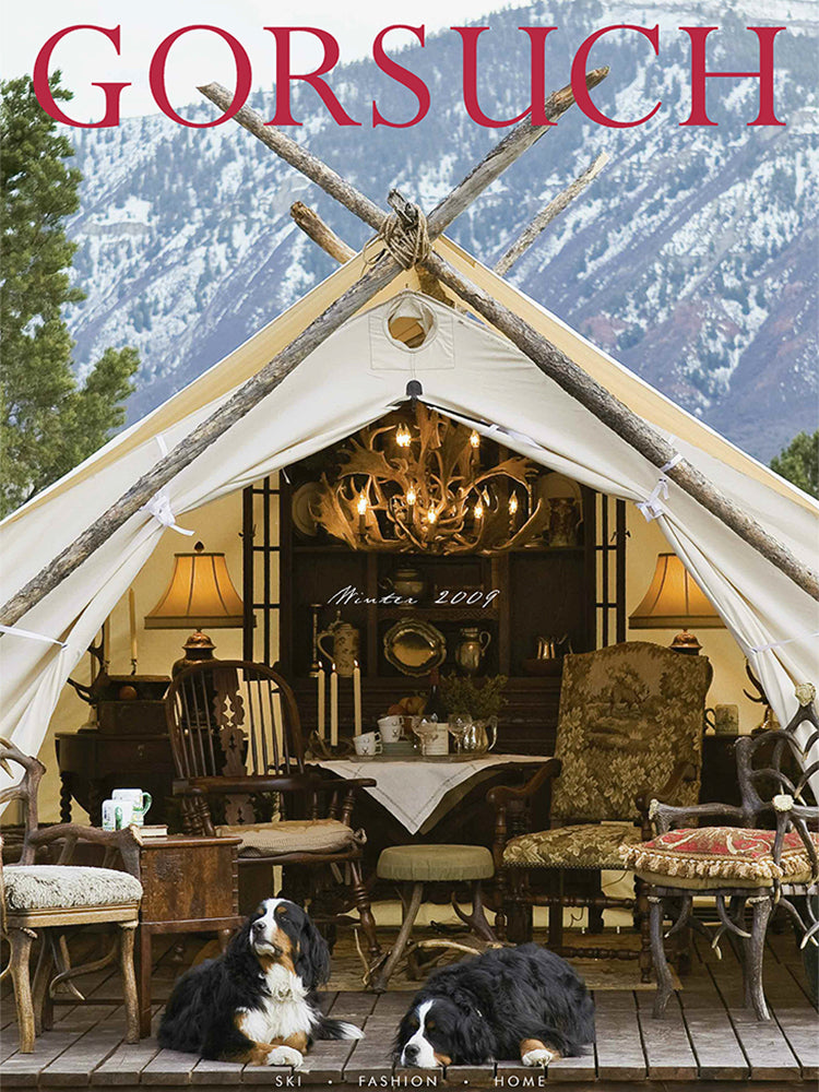 2009 Gorsuch catalog cover featuring a luxury tent with indoor furniture and decor, Bernese Mountain Dogs lying on the ground, mountains in the background.