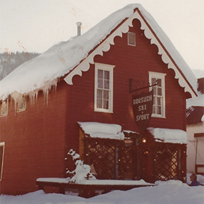 One of the original Gorsuch stores, painted red with white trim, featuring an exterior sign that reads 'Gorsuch Ski & Sport.'