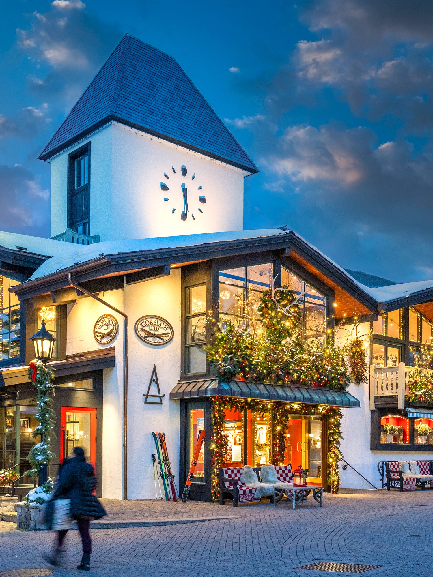 Vail Village Gorsuch store exterior with decorative Christmas elements at dusk.