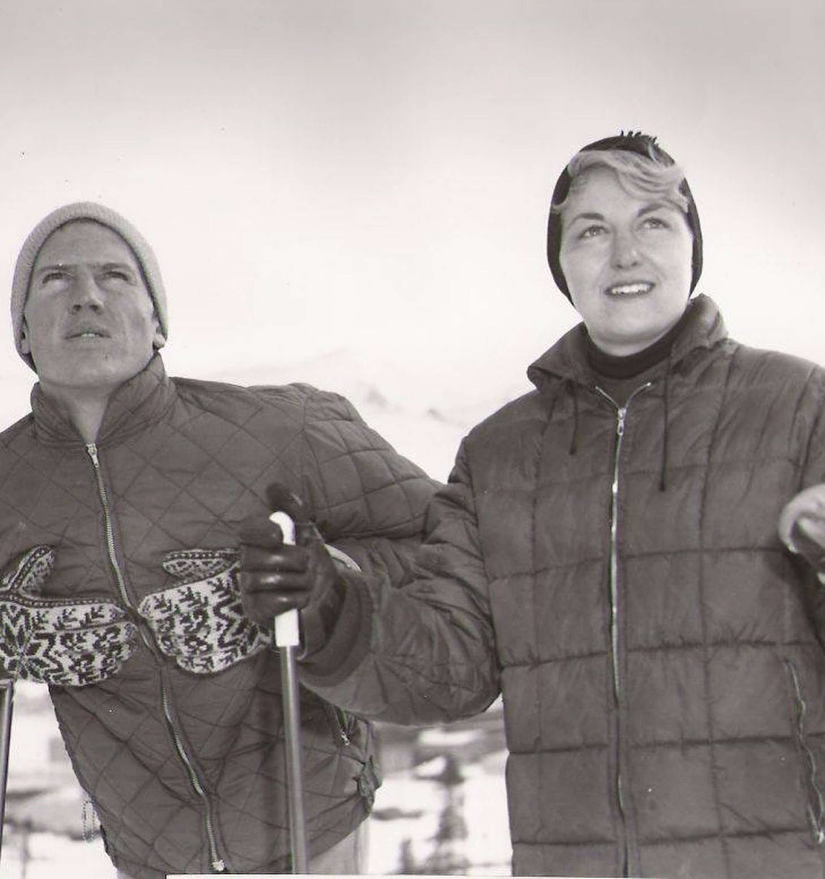 Vintage image of David and Renie Gorsuch in winter clothing with ski equipment on a snowy background.