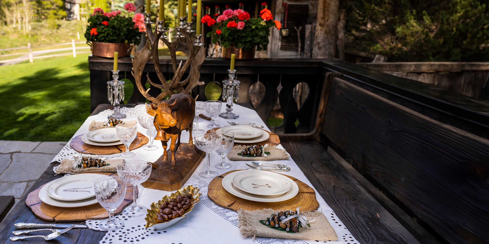 Dining table set with the Skier Plates, napkins, and decorative items outdoors.