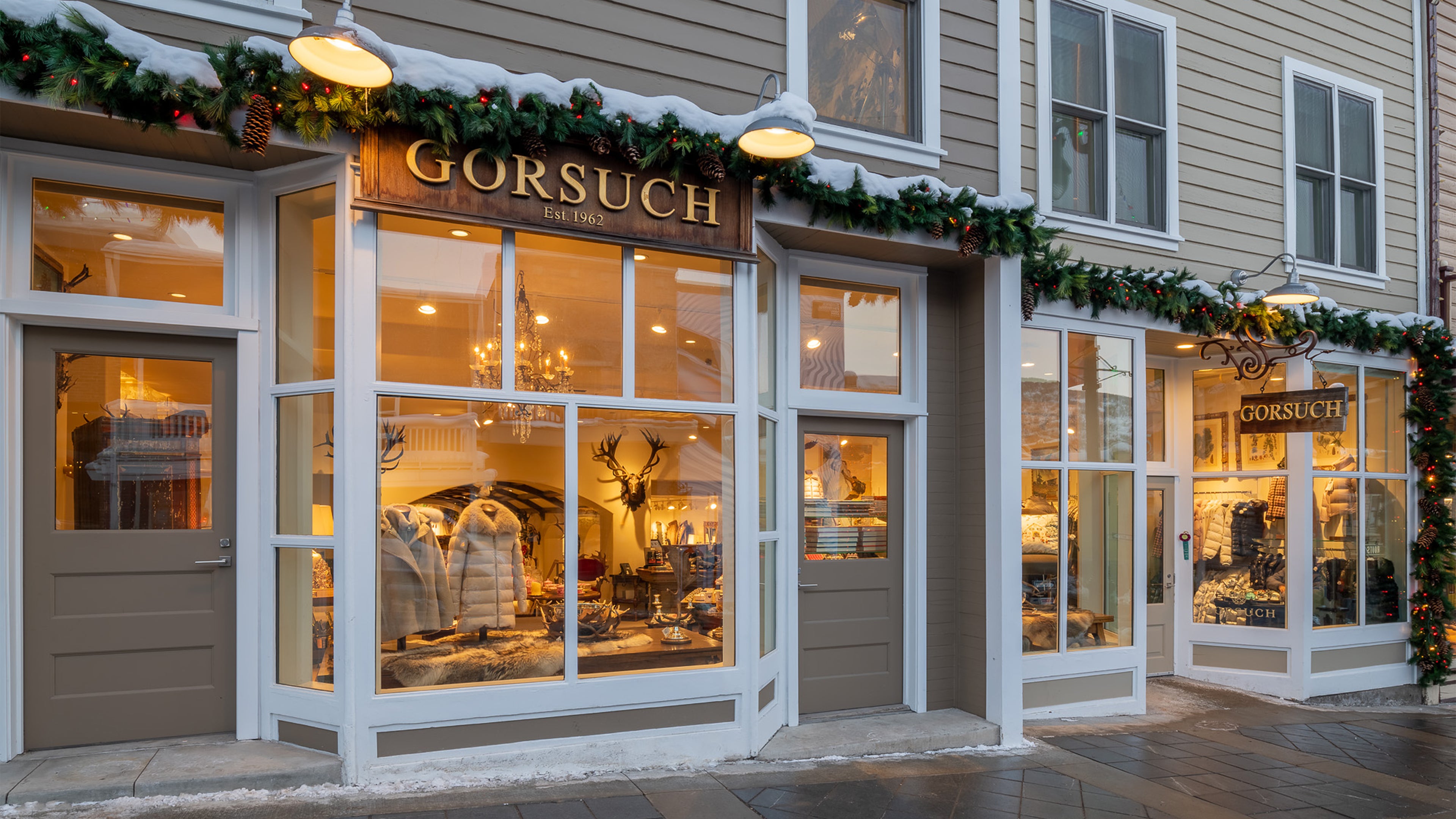 Storefront with 'Gorsuch' sign and Christmas decorations on a building exterior at the Gorusch Store in Park City.