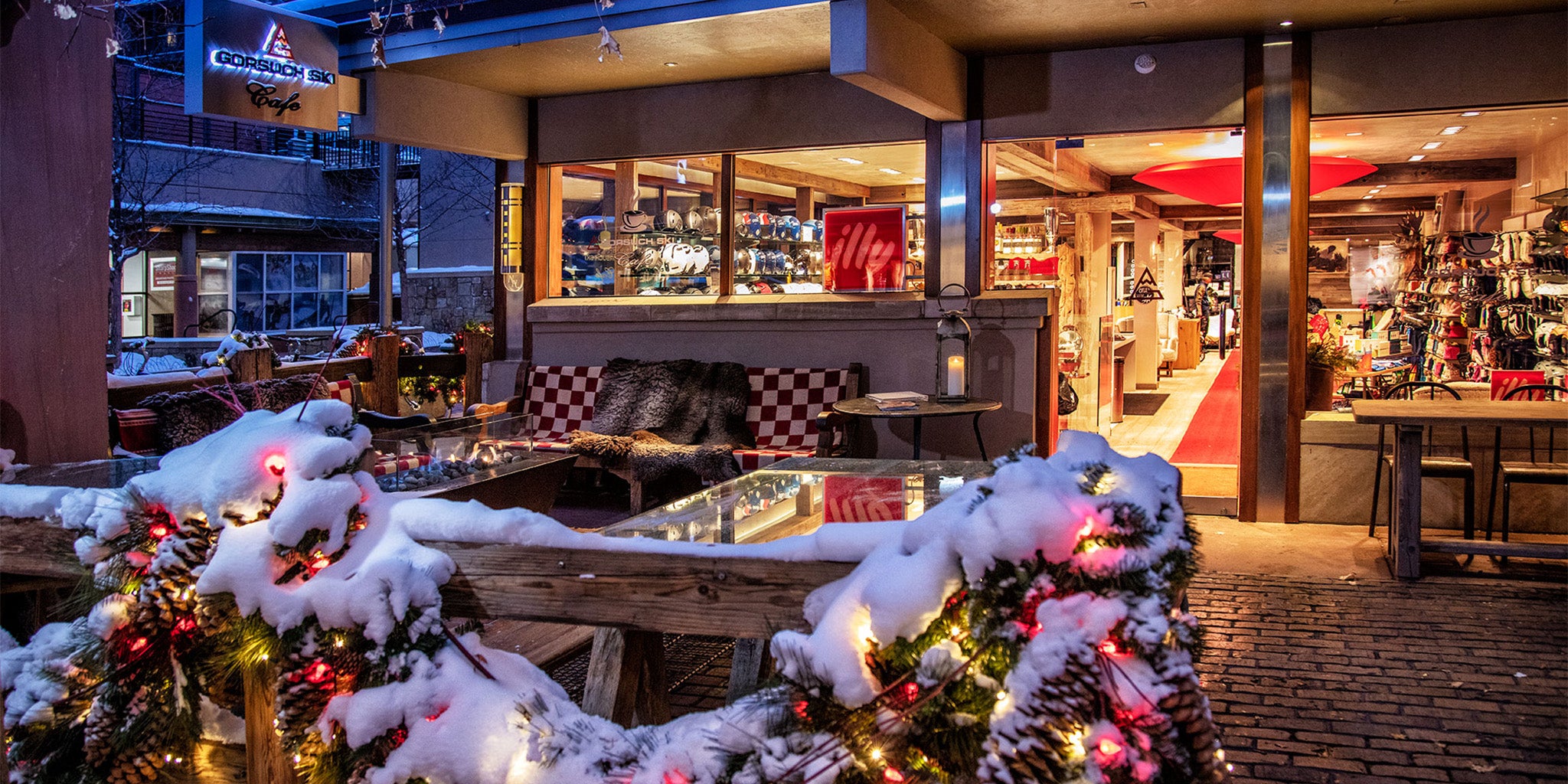Snow-covered outdoor area with Christmas decorations in a restaurant setting at the Gorsuch Ski Cafe in Aspen.