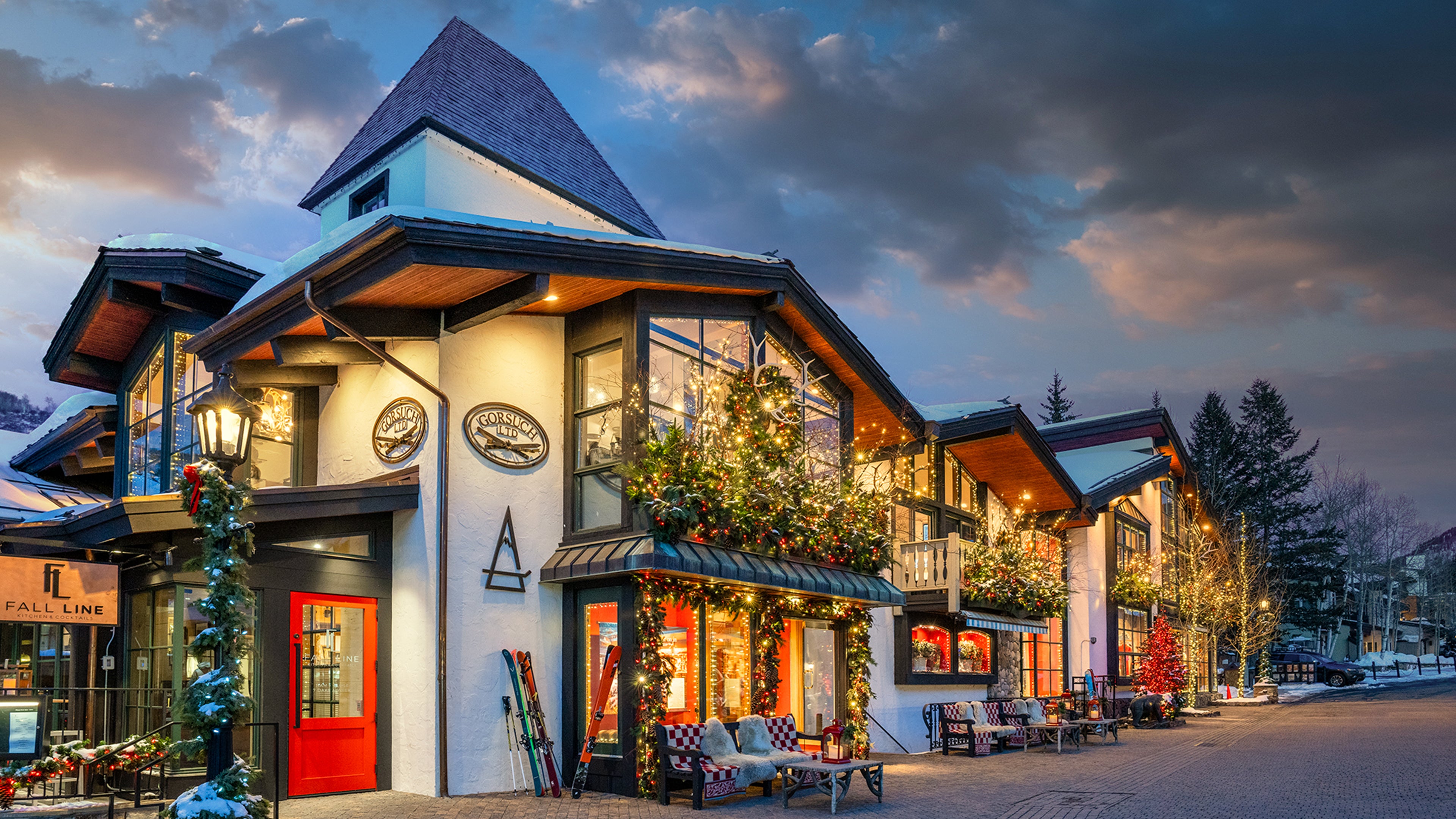 Vail Village Gorsuch store exterior with decorative Christmas elements at dusk.