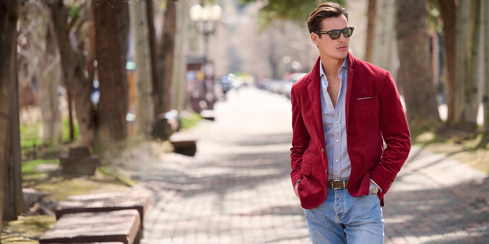 Man in the Corduroy Jacket by Brunello Cucinelli walking on a tree-lined street