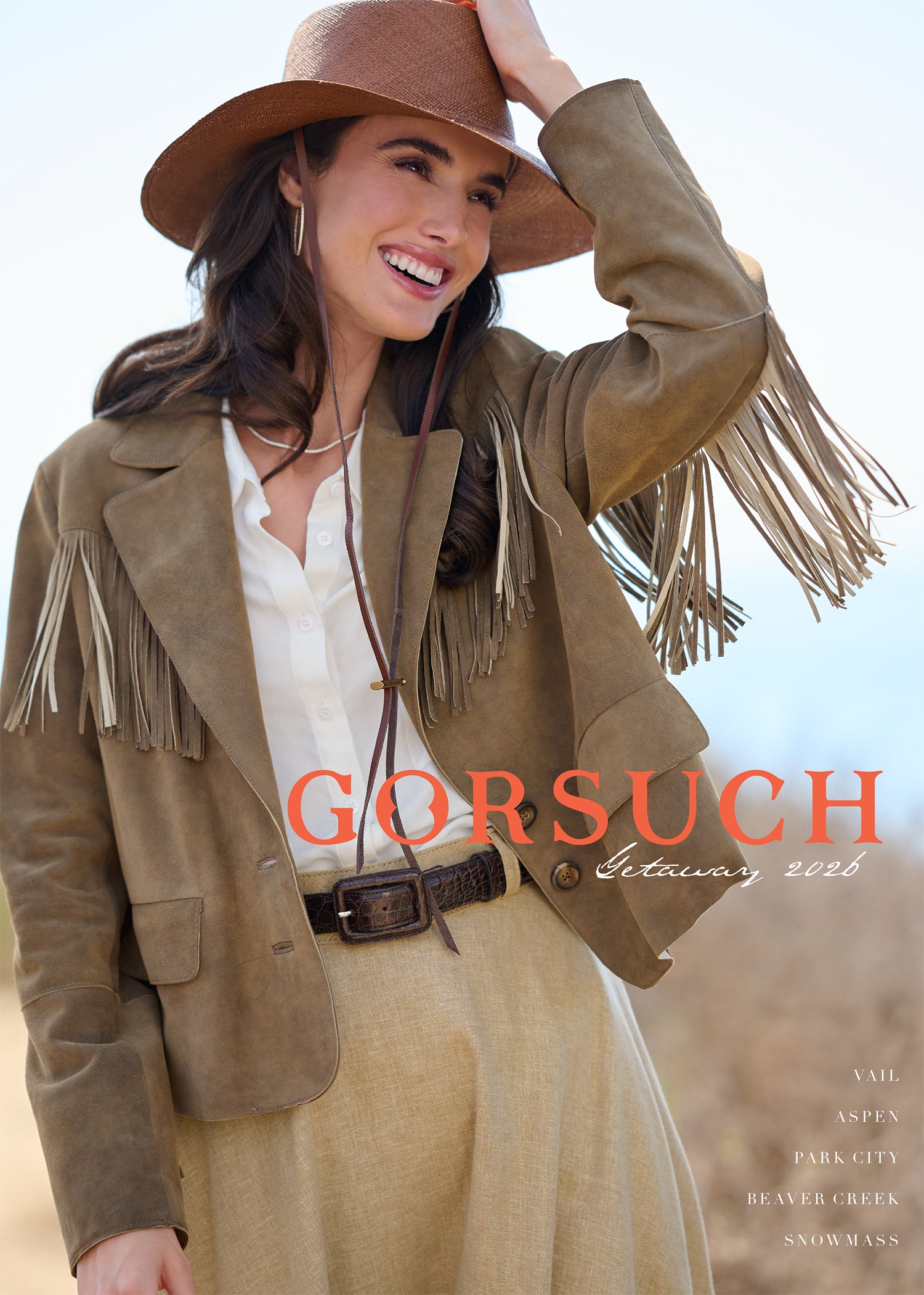 Woman wearing a fringed jacket and hat with 'Gorsuch' logo across front of catalog cover